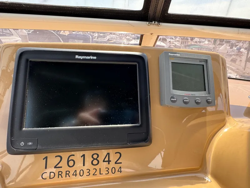 Dashboard of 2004 Carver 366 Motor Yacht with Raymarine displays and identification numbers.