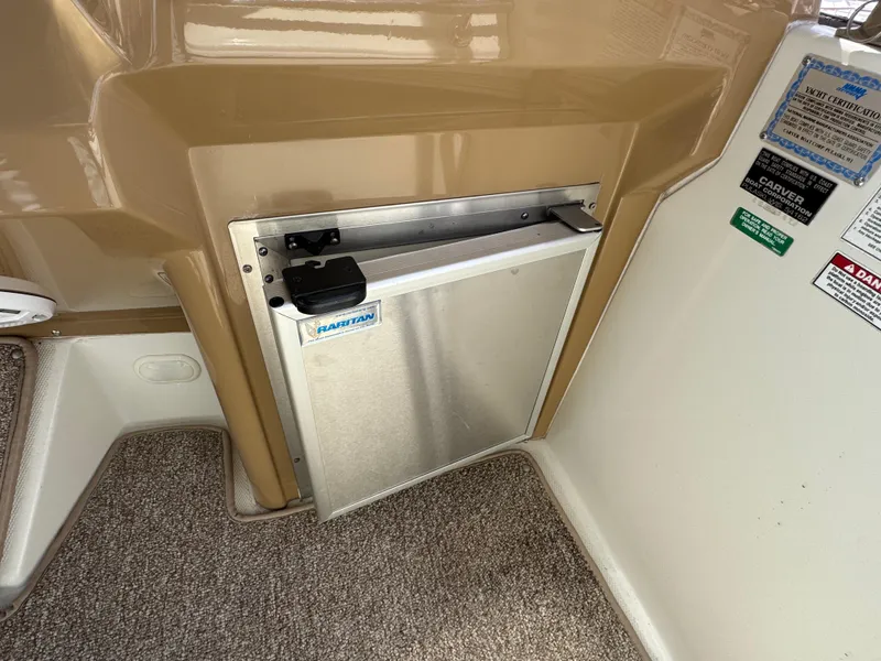 2004 Carver 366 Motor Yacht interior with built-in refrigerator and carpeted flooring.