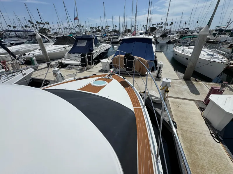 2004 Carver 366 Motor Yacht docked at a marina, surrounded by other boats.