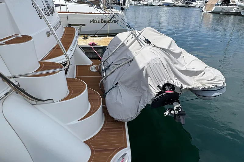 2004 Carver 366 Motor Yacht with covered dinghy at marina.