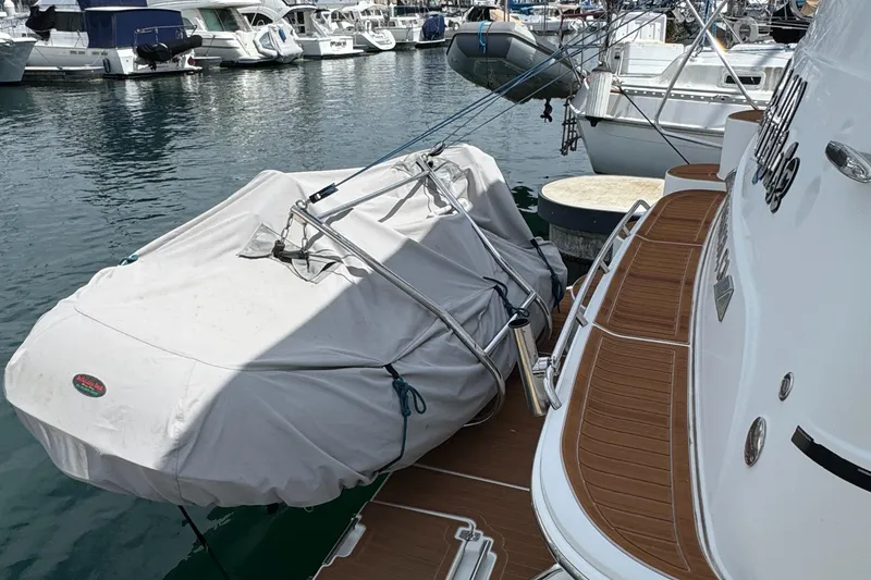 2004 Carver 366 Motor Yacht docked, covered with a protective tarp in a marina.