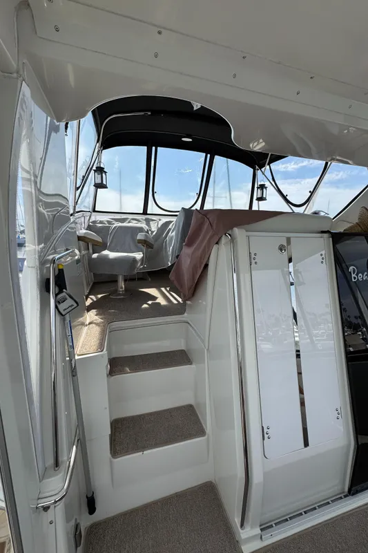 Interior view of 2004 Carver 366 Motor Yacht with stairs and seating area.