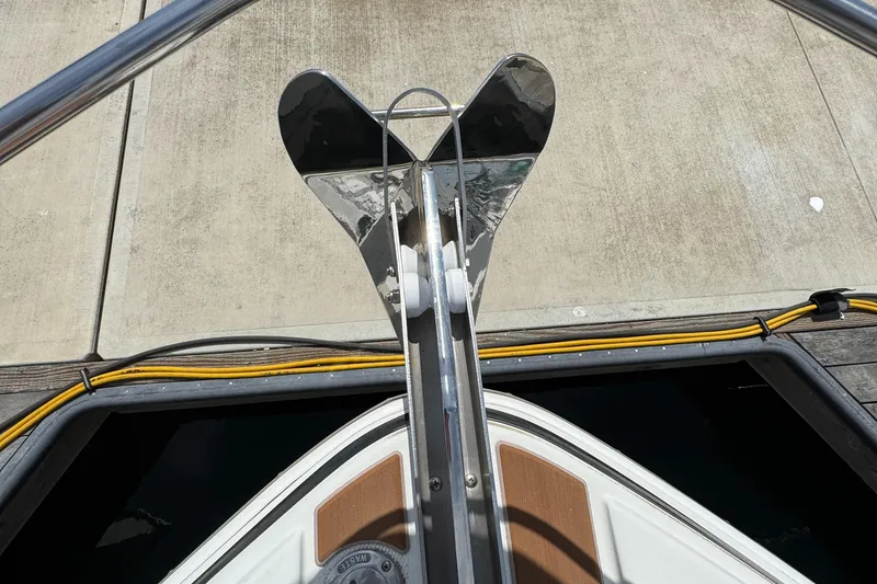 Bow view of 2004 Carver 366 Motor Yacht with polished anchor on dock.