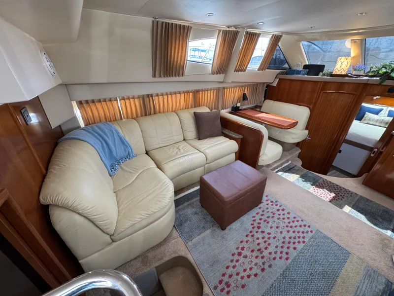 Luxurious interior of 2004 Carver 366 Motor Yacht with beige sofa and modern decor.