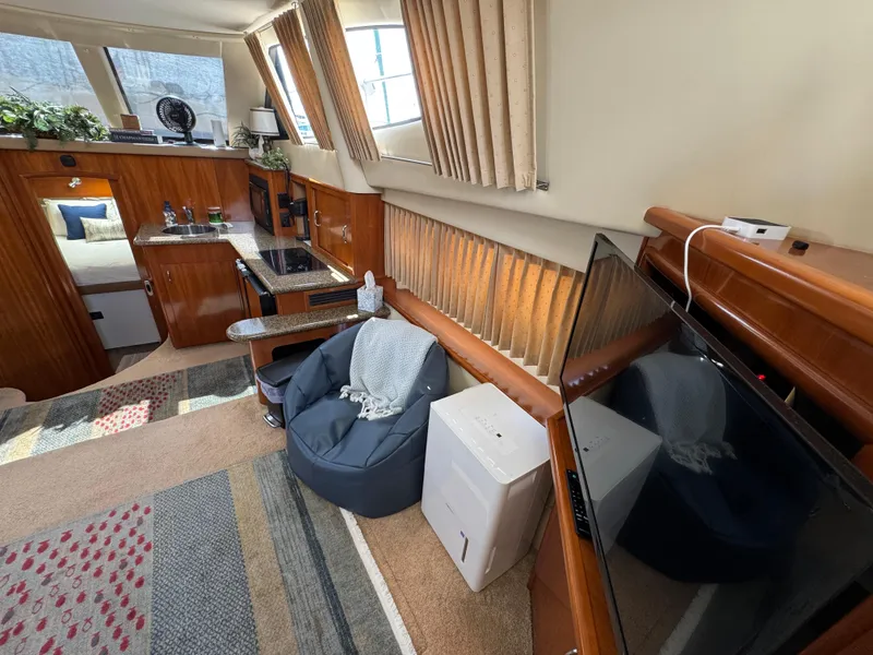 Interior of 2004 Carver 366 Motor Yacht with cozy seating and modern amenities.