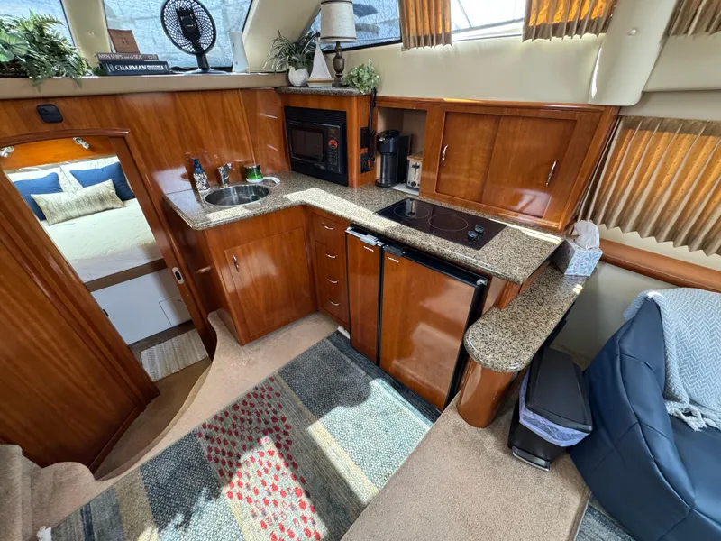 Luxurious 2004 Carver 366 Motor Yacht interior with modern kitchen and cozy seating area.