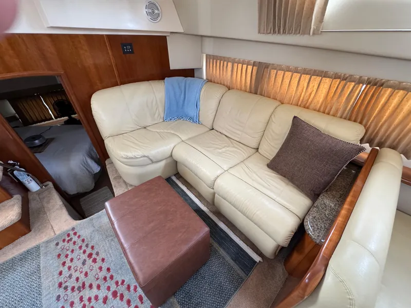 Luxurious interior of 2004 Carver 366 Motor Yacht with beige leather seating and cozy decor.