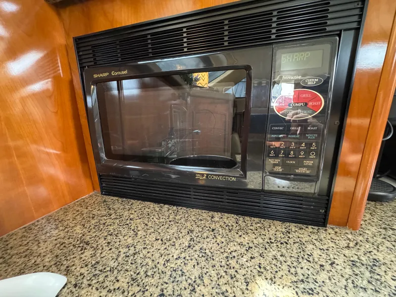 Microwave oven in 2004 Carver 366 Motor Yacht kitchen with granite countertop.