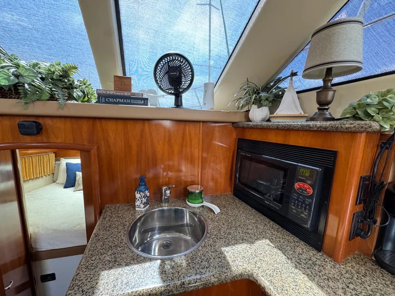 Interior of 2004 Carver 366 Motor Yacht with kitchenette, sink, and microwave.