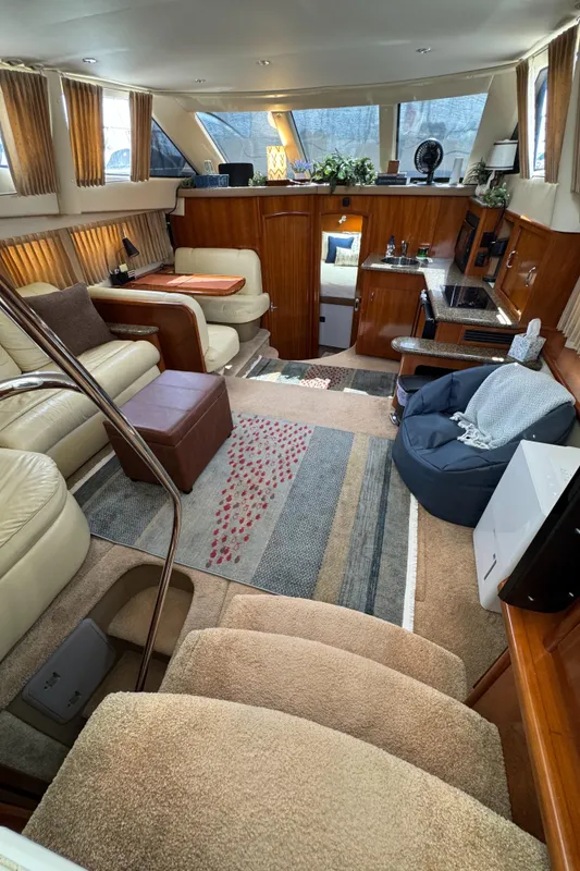 Luxurious interior of 2004 Carver 366 Motor Yacht with plush seating and elegant decor.