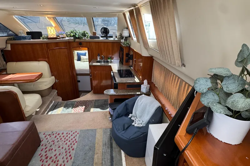 Interior of 2004 Carver 366 Motor Yacht with cozy seating and modern decor.