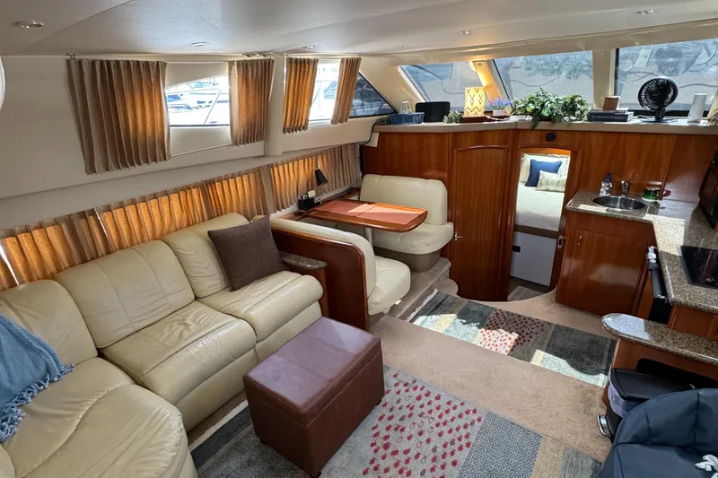 Luxurious interior of a 2004 Carver 366 Motor Yacht with plush seating and elegant wood finishes.