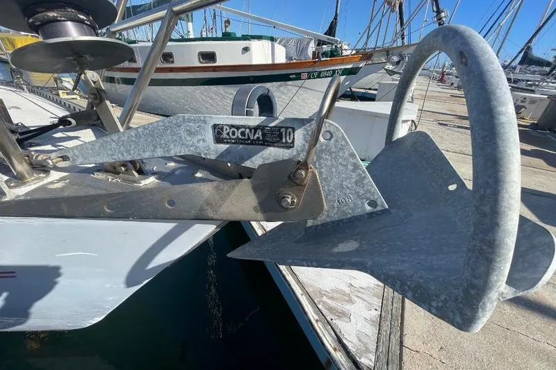 Rocna anchor on Custom Bodega 30 sailboat, 1977 model, docked at marina.