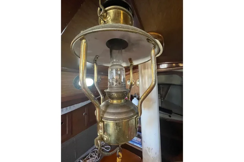 Vintage brass lantern inside a 1977 Custom Bodega 30 boat cabin.