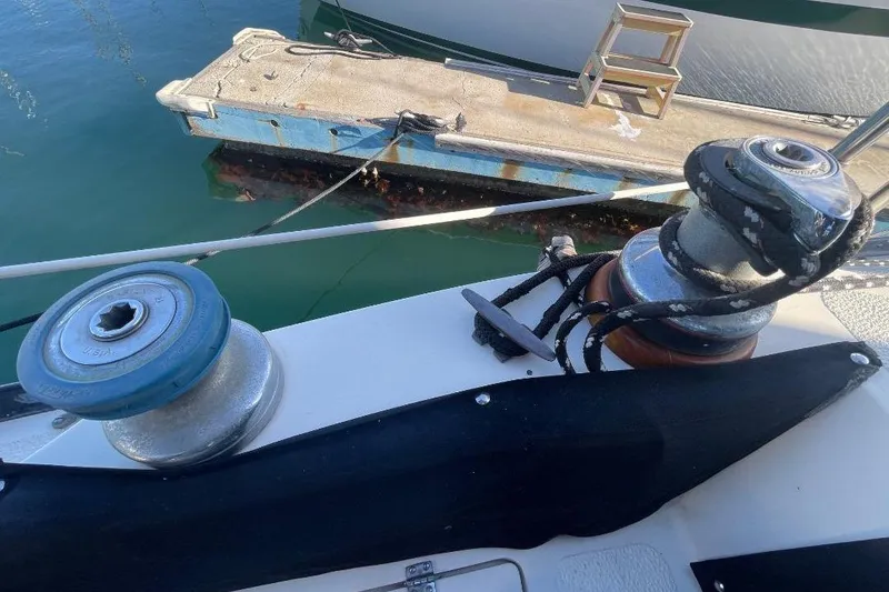 Winches on a 1977 Custom Bodega 30 sailboat near a dock.