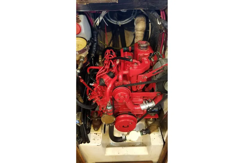 Red engine of a 1977 Custom Bodega 30 boat, detailed view.