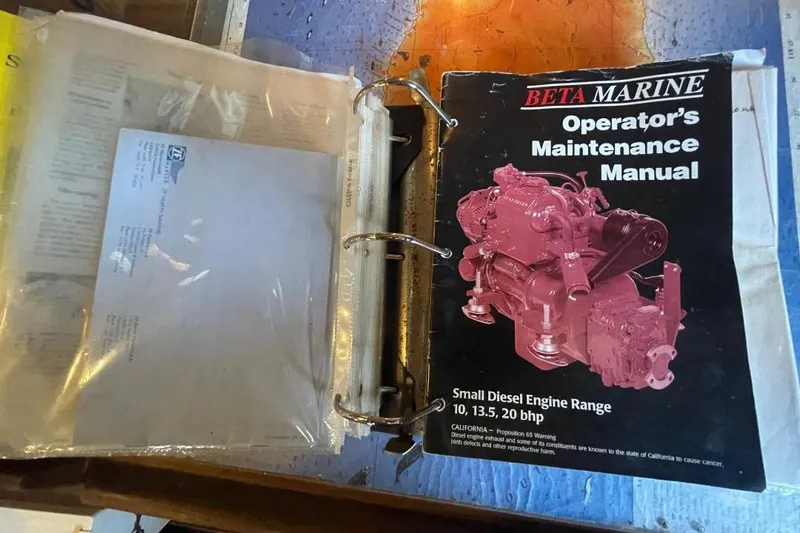 Binder with Beta Marine operator's maintenance manual for small diesel engines, Custom Bodega 30, 1977.
