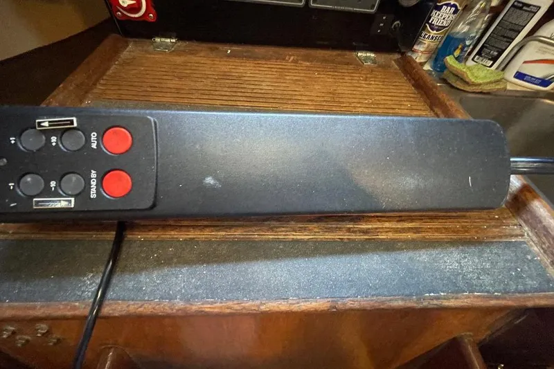 Remote control on wooden surface, part of a 1977 Custom Bodega 30 setup.