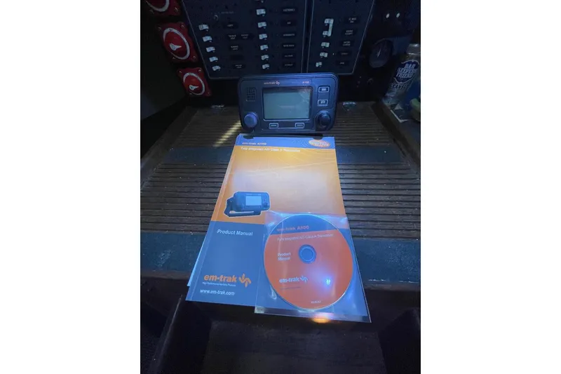 Em-trak AIS transceiver with manual and CD on a Custom Bodega 30, 1977 model.