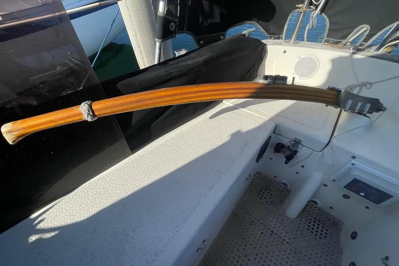 Wooden tiller on a 1977 Custom Bodega 30 sailboat, cockpit view.