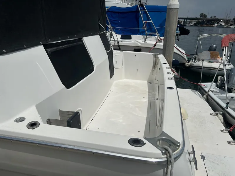 1994 Bayliner 4587 Motoryacht docked, featuring spacious deck area and mooring lines.