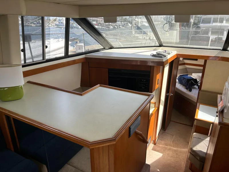 Interior of 1994 Bayliner 4587 Motoryacht with spacious seating and large windows.