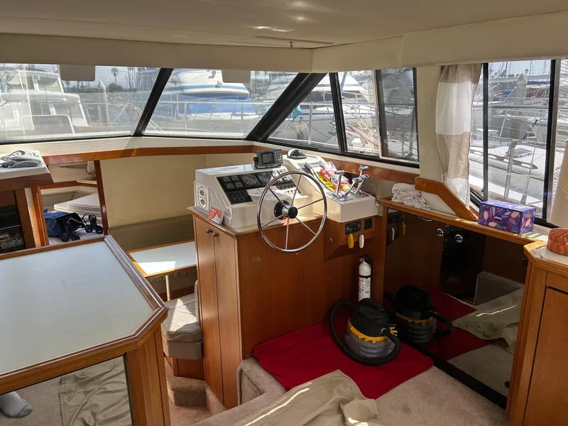 Interior of 1994 Bayliner 4587 Motoryacht with helm, windows, and nautical equipment.