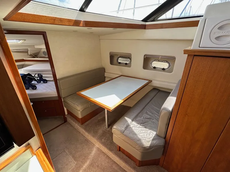 1994 Bayliner 4587 Motoryacht interior with dining area, table, and seating.