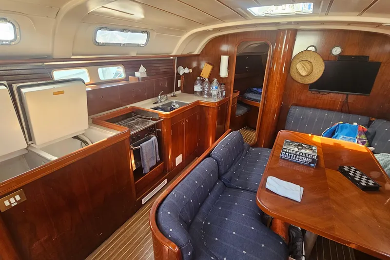 Interior of 1996 Beneteau Oceanis 440 sailboat with kitchen and seating area.