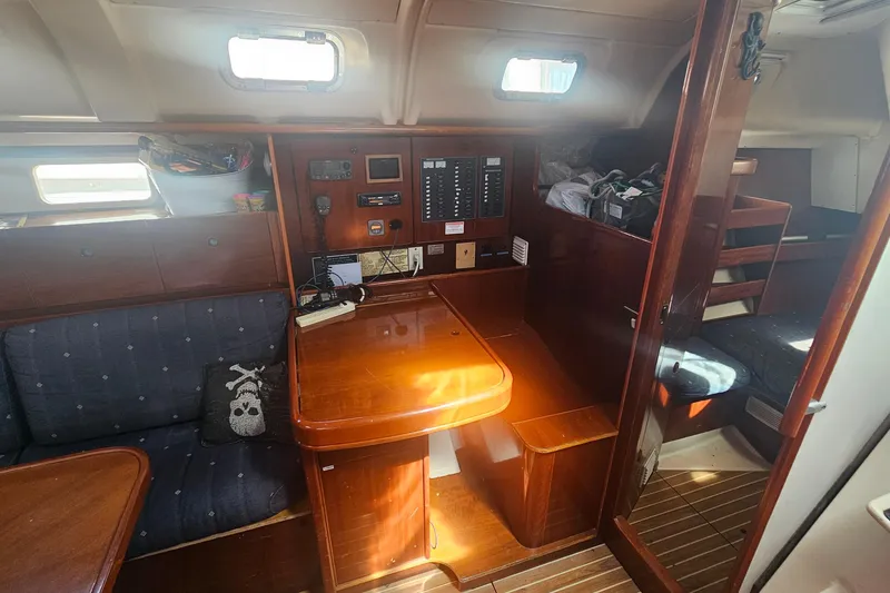 Interior of 1996 Beneteau Oceanis 440 sailboat with wooden furnishings and navigation equipment.