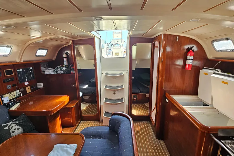 Interior of 1996 Beneteau Oceanis 440 sailboat with wood finish and seating area.