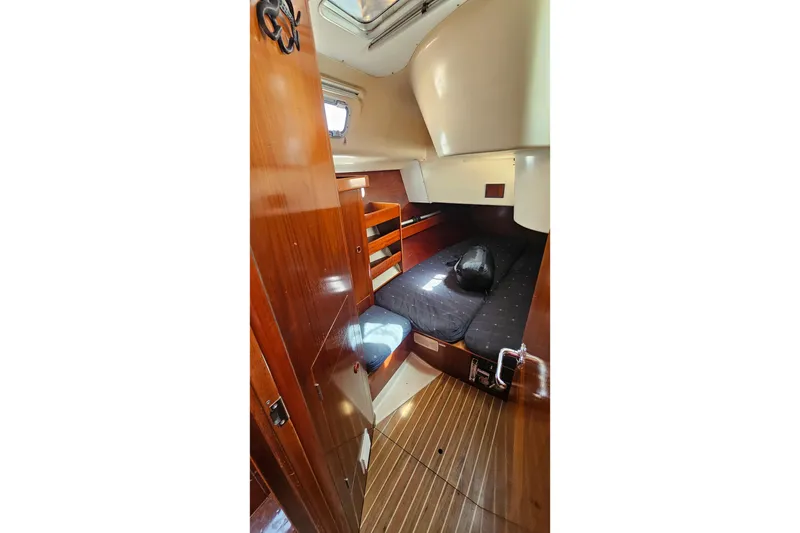 Cozy cabin interior of 1996 Beneteau Oceanis 440 sailboat with wooden finishes.