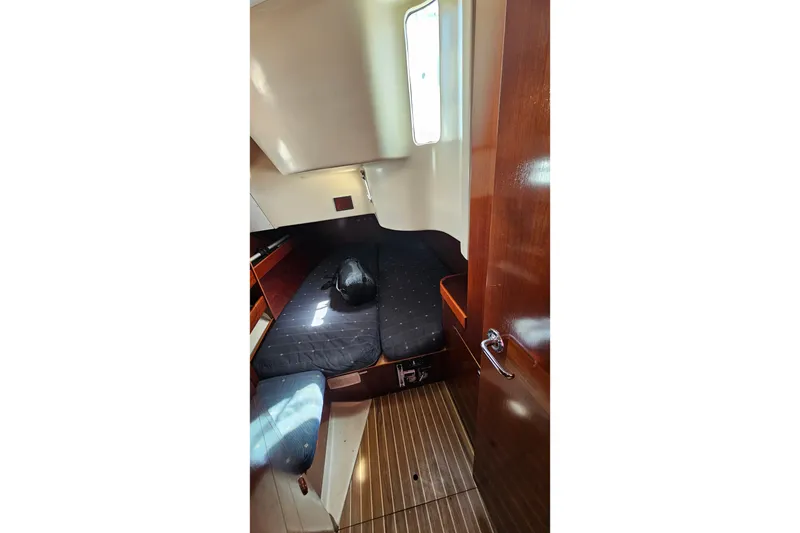 Interior cabin of 1996 Beneteau Oceanis 440 sailboat with wooden flooring.
