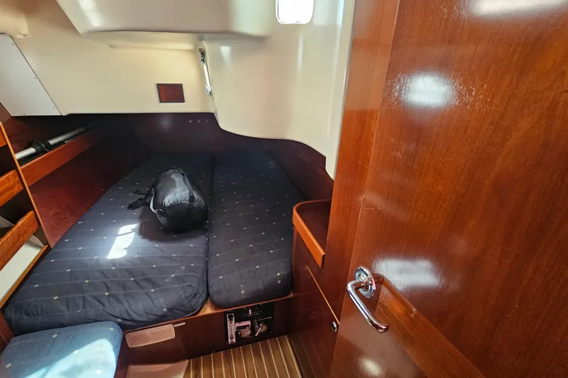 Cozy cabin interior of 1996 Beneteau Oceanis 440 sailboat with wooden finish.