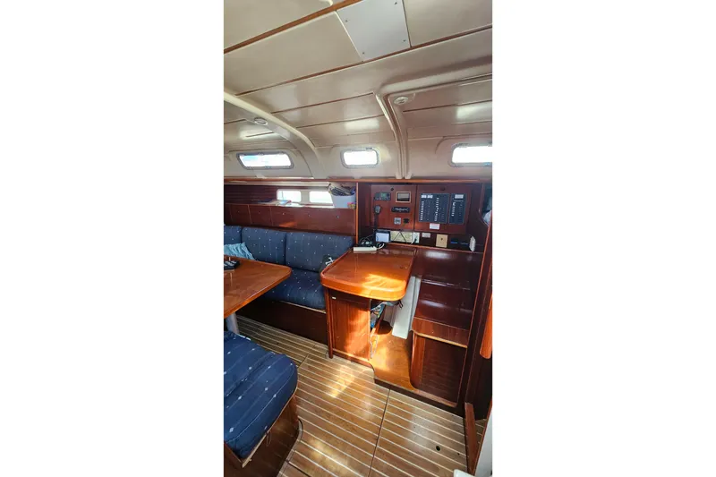 Interior of 1996 Beneteau Oceanis 440 sailboat with wood finish and seating area.