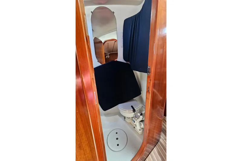 Interior view of 1996 Beneteau Oceanis 440 yacht bathroom with wooden finish.