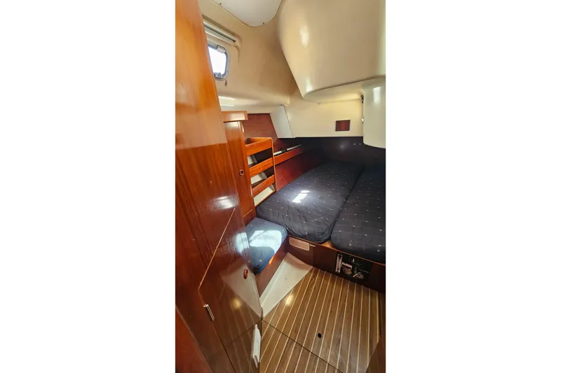 Cozy cabin interior of 1996 Beneteau Oceanis 440 sailboat with wooden finishes.