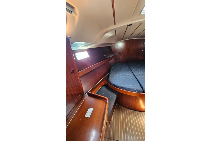 Cozy cabin interior of 1996 Beneteau Oceanis 440 sailboat with wooden furnishings.