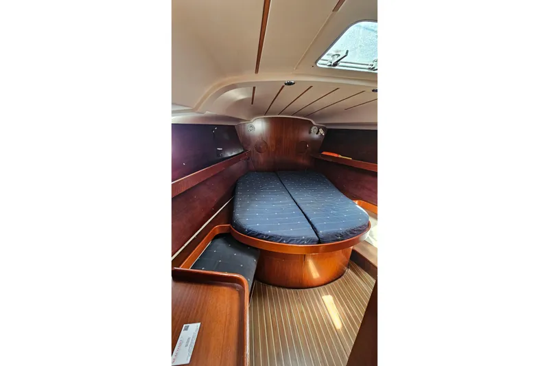Cozy cabin interior of 1996 Beneteau Oceanis 440 sailboat with wooden finish and skylight.