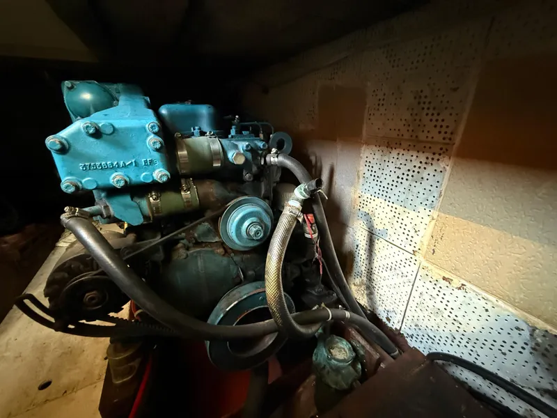 Engine of 1981 DeFever Passagemaker boat, featuring blue components and hoses.
