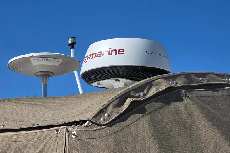 Radar and antenna on 2002 Sea Ray 340 Sundancer against clear blue sky.