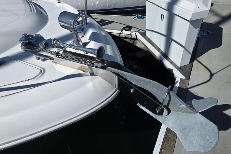 Bow of 2002 Sea Ray 340 Sundancer with anchor and chain at dock.
