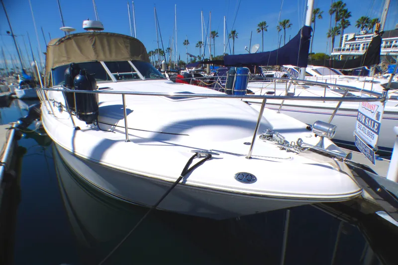 2002 Sea Ray 340 Sundancer yacht docked, for sale sign visible.