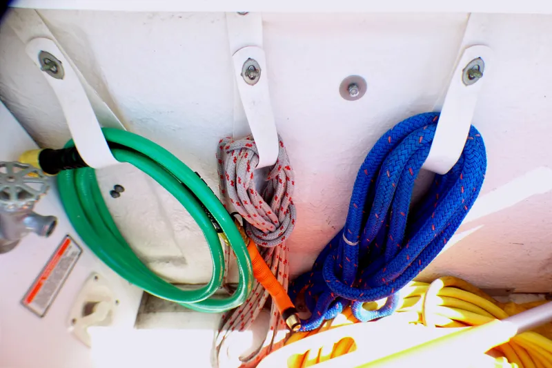 Colorful ropes and hose stored on a 2002 Sea Ray 340 Sundancer boat.