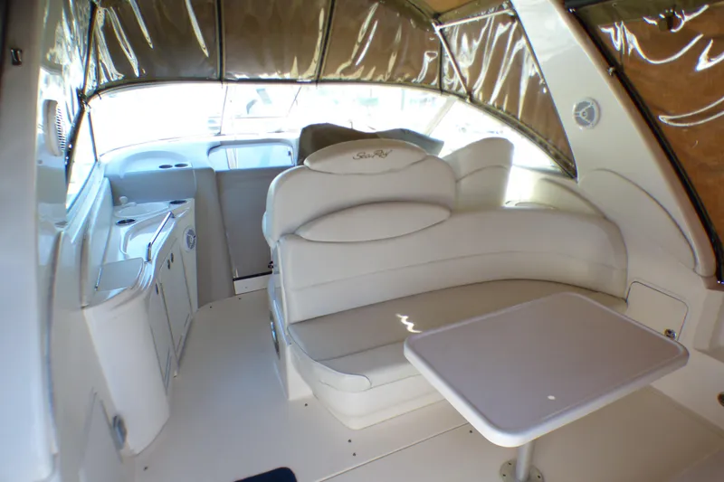 Interior of 2002 Sea Ray 340 Sundancer boat with white seating and table.