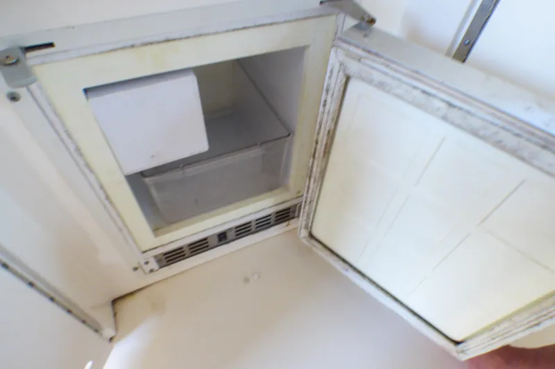 Open refrigerator compartment on 2002 Sea Ray 340 Sundancer boat.