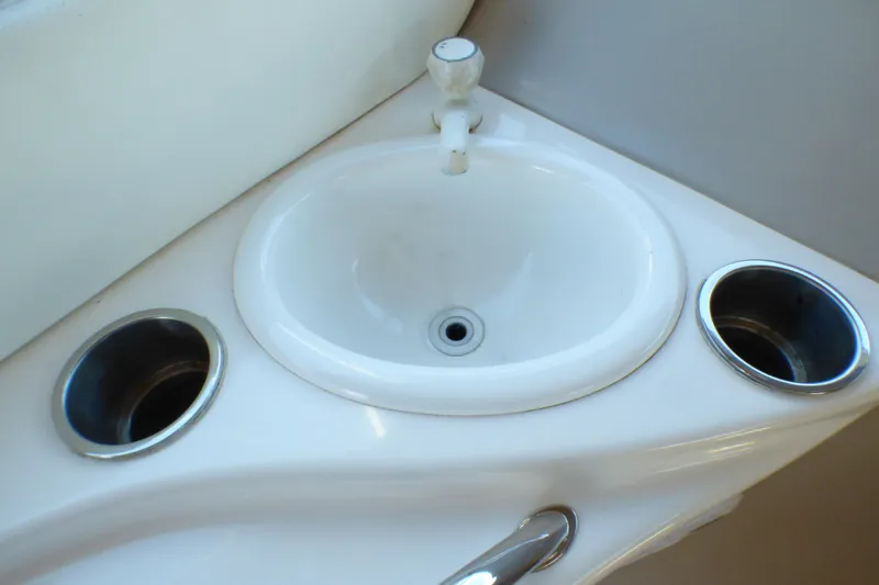 Small white sink with faucet on 2002 Sea Ray 340 Sundancer boat.