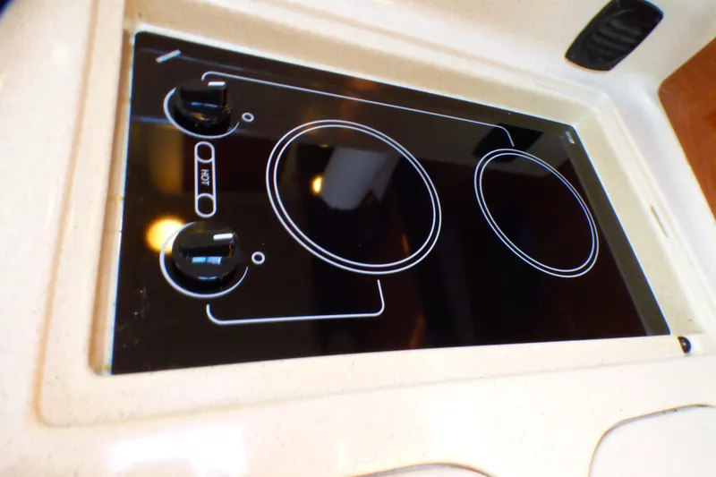 Stovetop on 2002 Sea Ray 340 Sundancer yacht, featuring dual burners and sleek design.