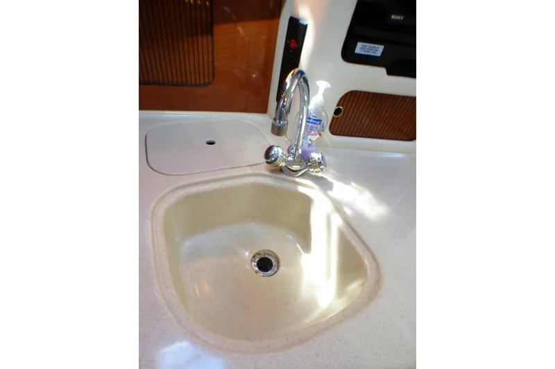 2002 Sea Ray 340 Sundancer kitchen sink with faucet and soap dispenser.