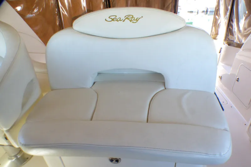 White leather seat on 2002 Sea Ray 340 Sundancer boat, featuring embroidered logo.